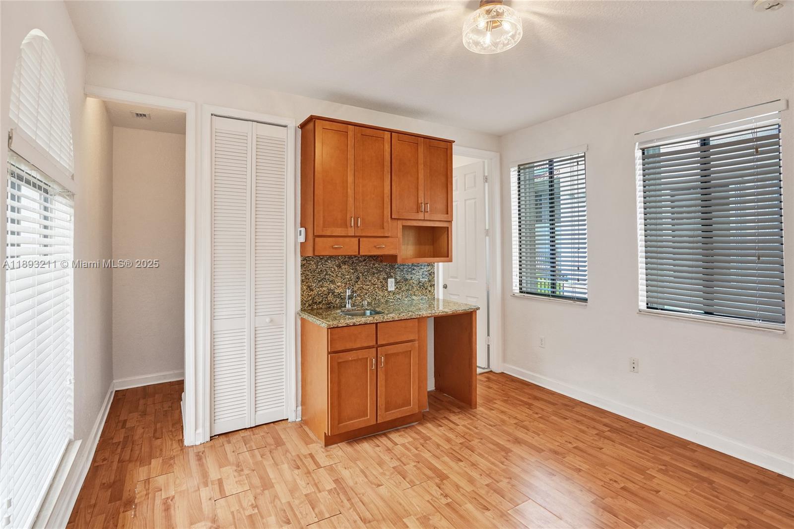 7722 Southwest 188th Terrace Cutler Bay, FL 33157 - Photo 70 of 89 a view of kitchen with granite countertop cabinets and wooden floor