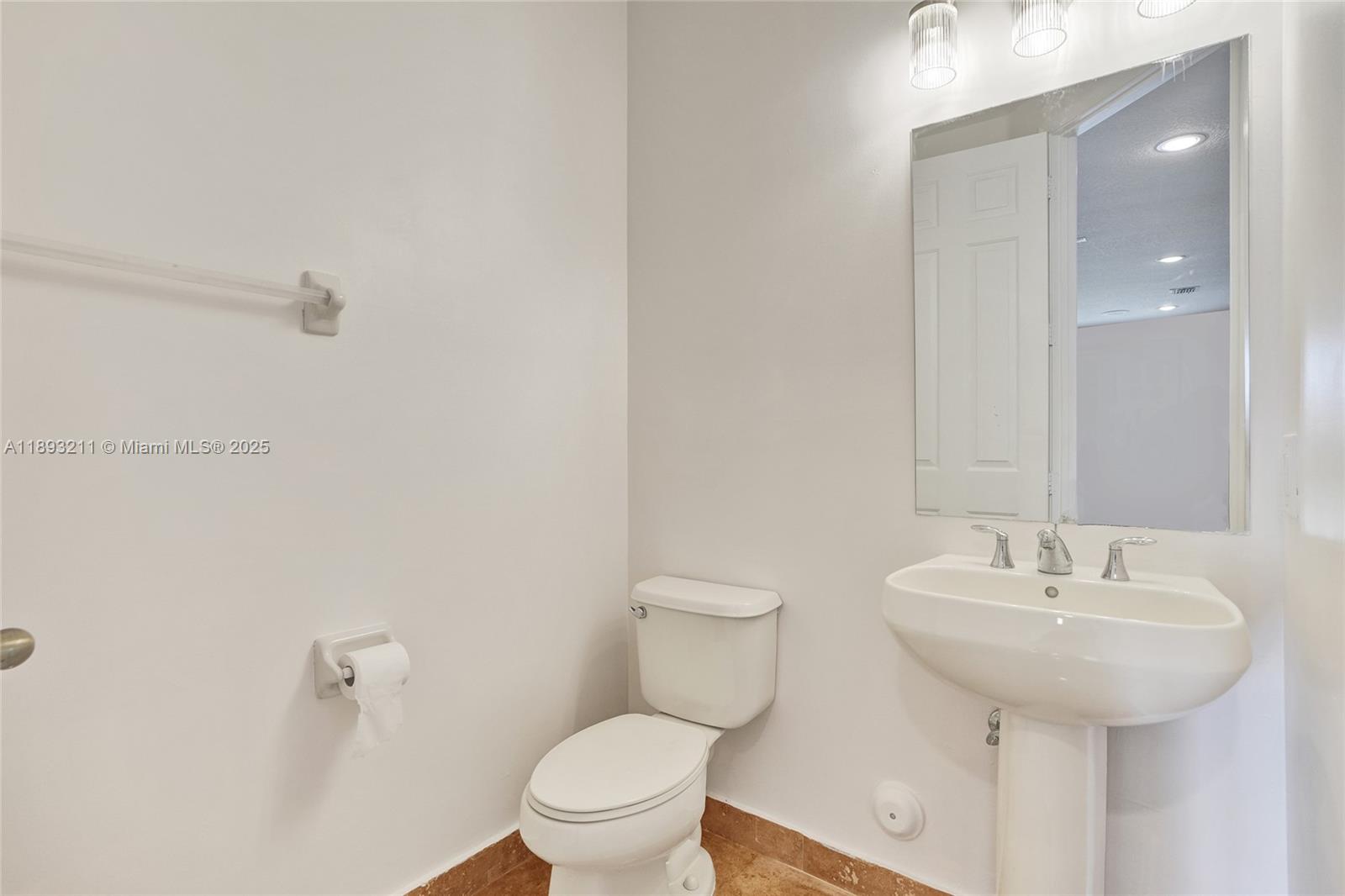 7722 Southwest 188th Terrace Cutler Bay, FL 33157 - Photo 74 of 89 a bathroom with a sink toilet and a mirror