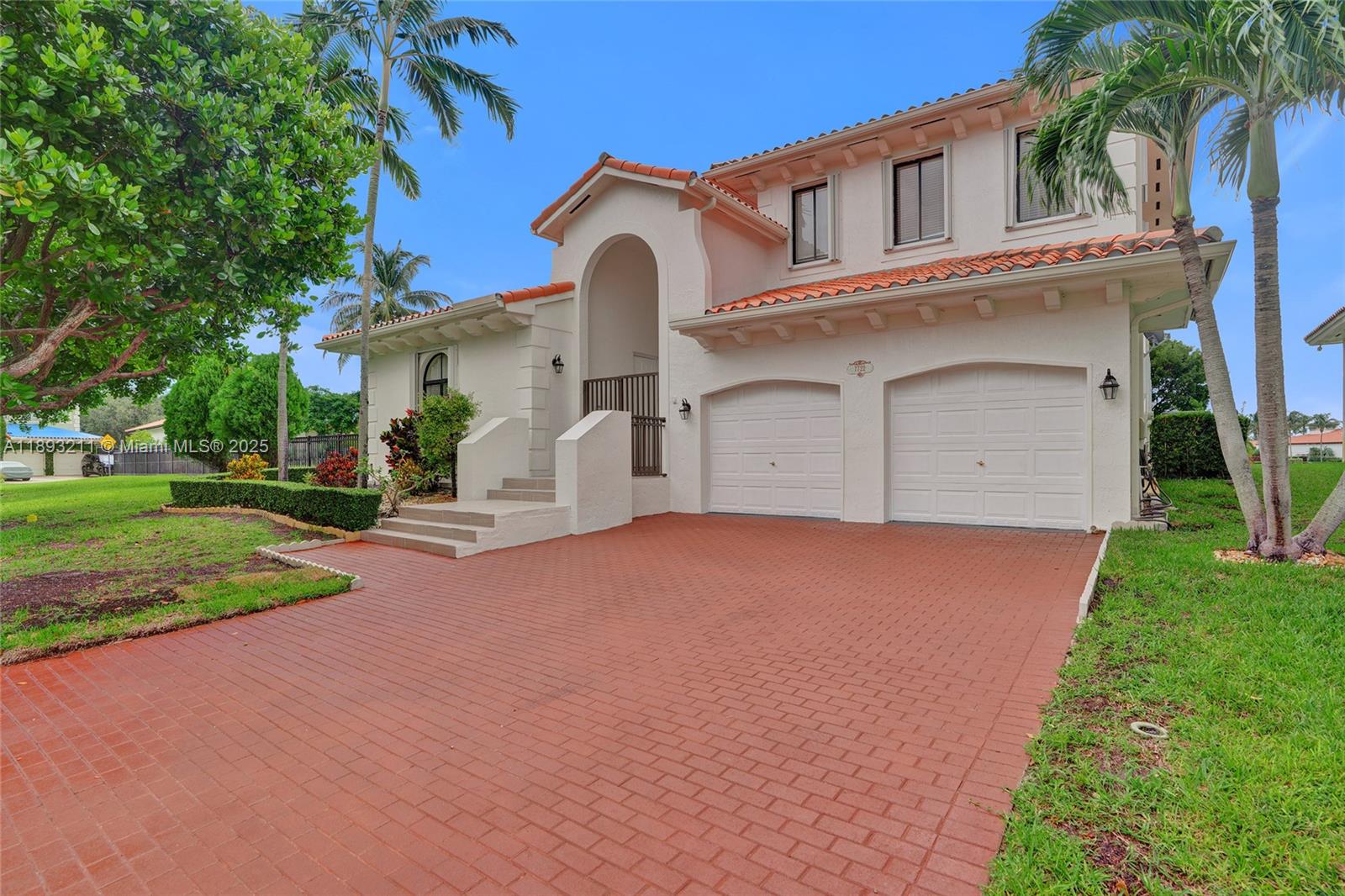 7722 Southwest 188th Terrace Cutler Bay, FL 33157 - Photo 8 of 89 a front view of a house with a yard and garage