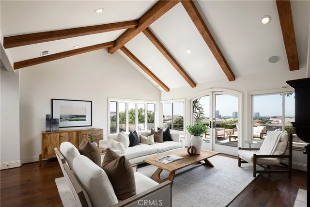 a living room with furniture and a floor to ceiling window