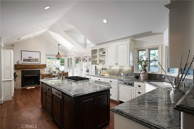 a kitchen with a stove and white cabinets