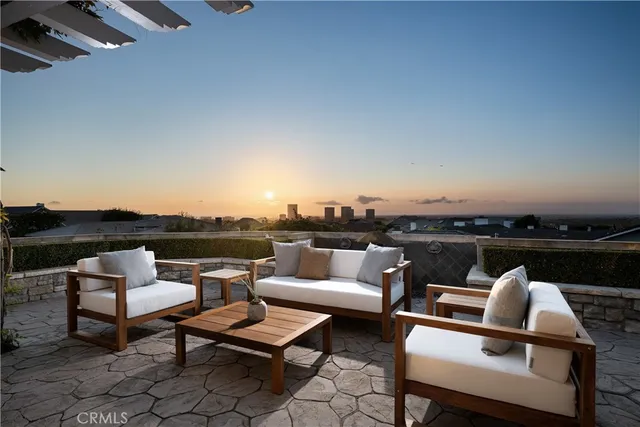 a terrace with outdoor seating and city view