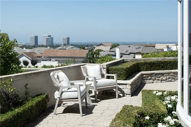 a view of a terrace with chairs and a potted plant