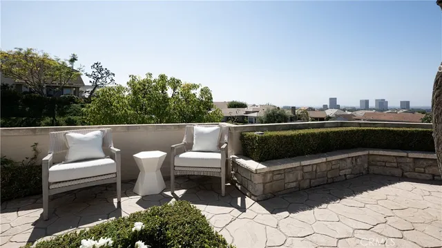 a terrace with outdoor seating and trees