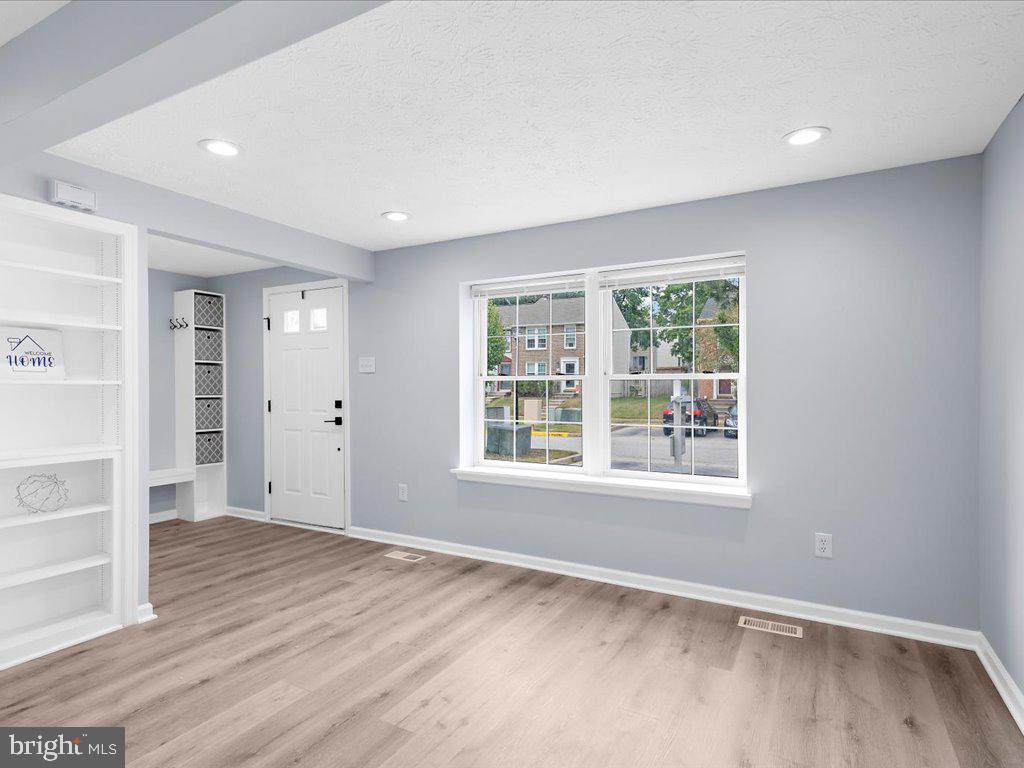 15 Ramsgate Court Halethorpe, MD 21227 - Photo 9 of 48 Luxury vinyl plank runs through the main level