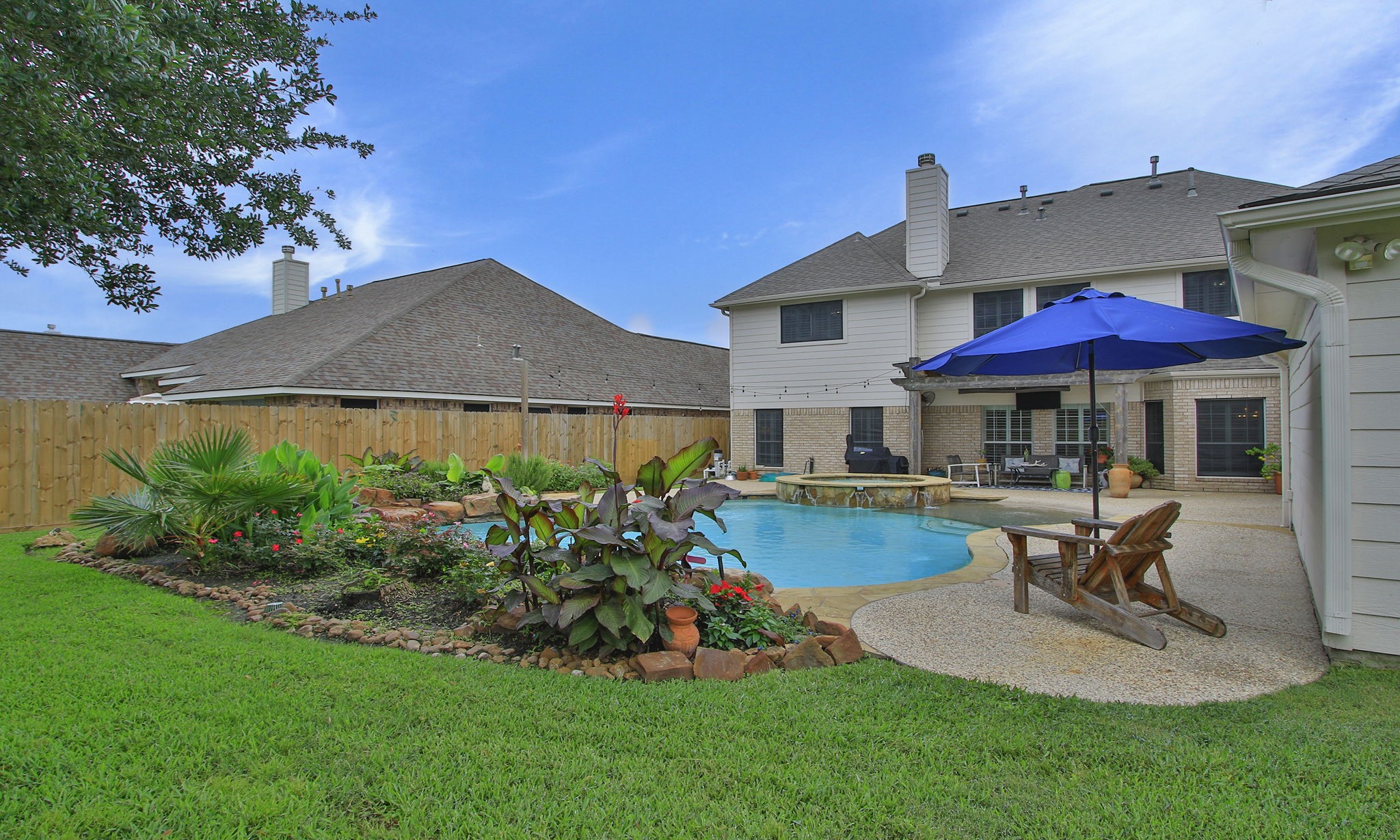 8419 Marchelle Lane Spring, TX 77379 - Photo 34 of 42 a view of a house with backyard sitting area and garden