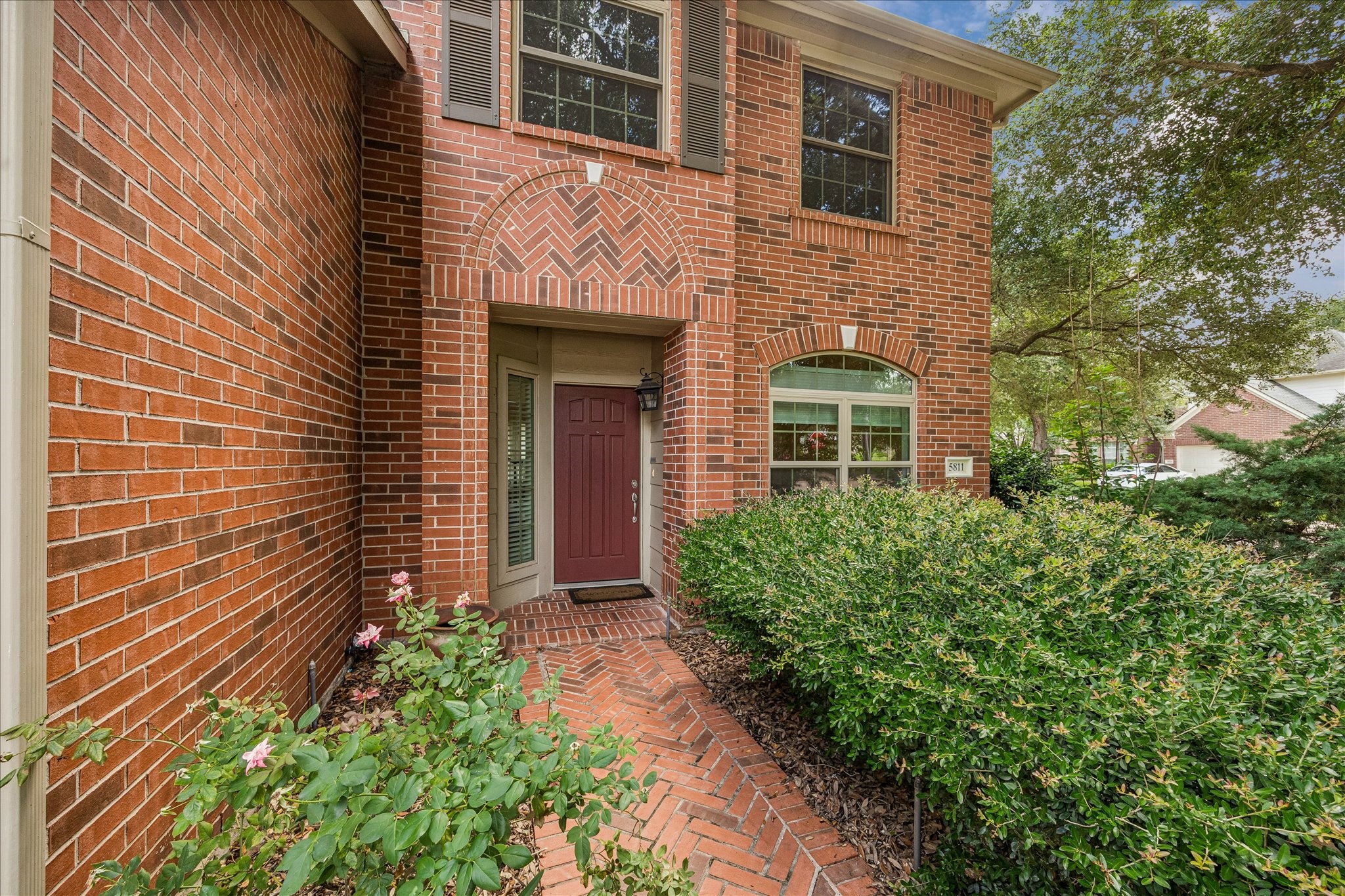 5811 Walkabout Way Katy, TX 77450 - Photo 11 of 33 Inviting covered entry highlighted by charming brick detailing, established landscaping, and a welcoming front door.