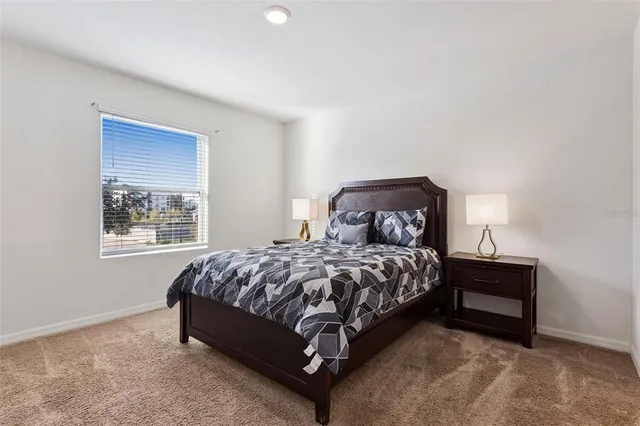 a bed sitting in a bedroom next to a window