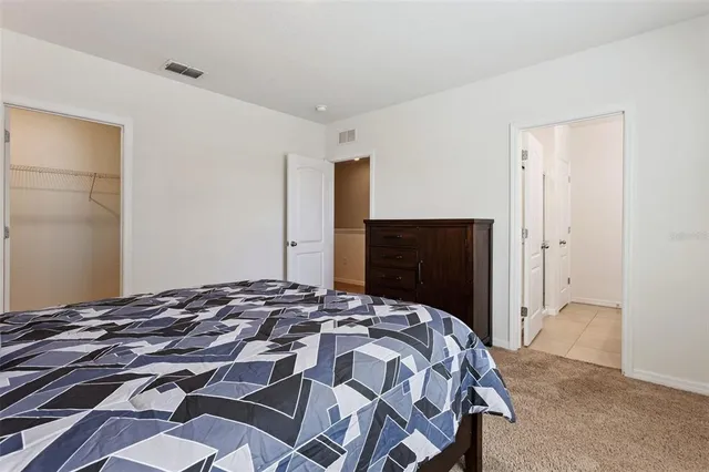 a bedroom with a bed and a dresser