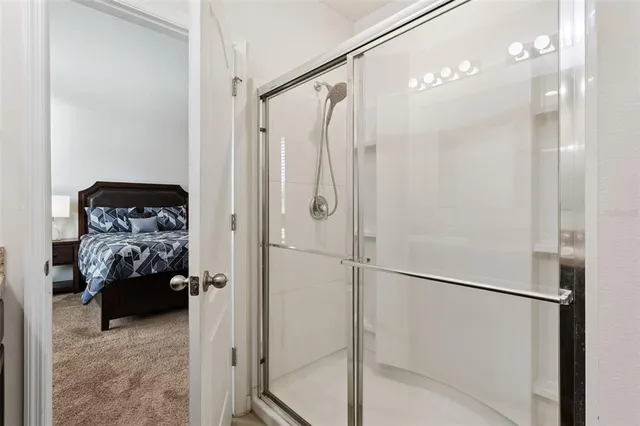 a bathroom with a shower and a glass door