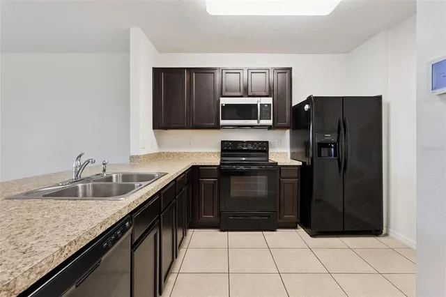 a kitchen with a refrigerator sink and microwave