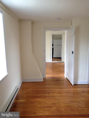 a view of a hallway with wooden floor