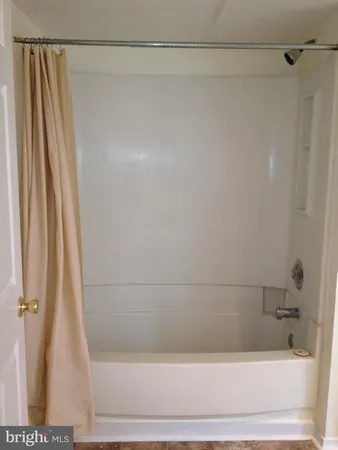 a bathroom with a shower and a bath tub