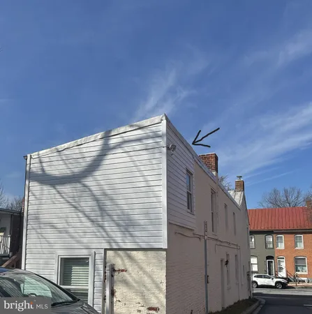 a tall brick building with a small yard