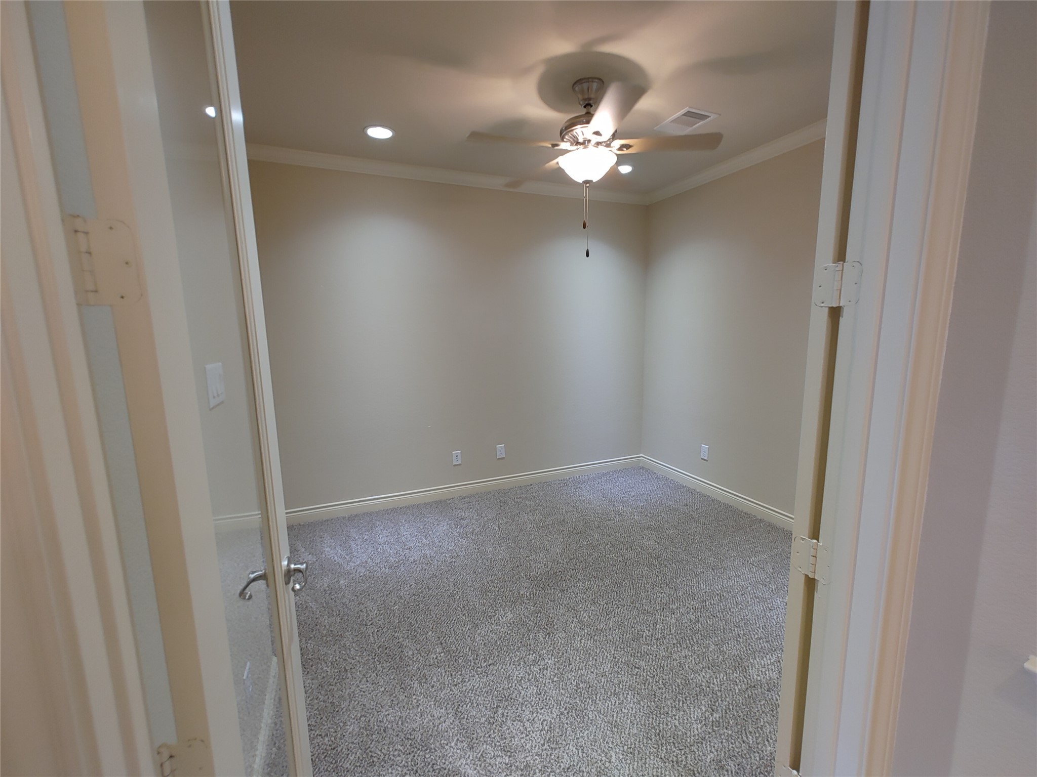 9014 Meacom Drive Conroe, TX 77384 - Photo 25 of 37 a view of an empty room with a chandelier fan
