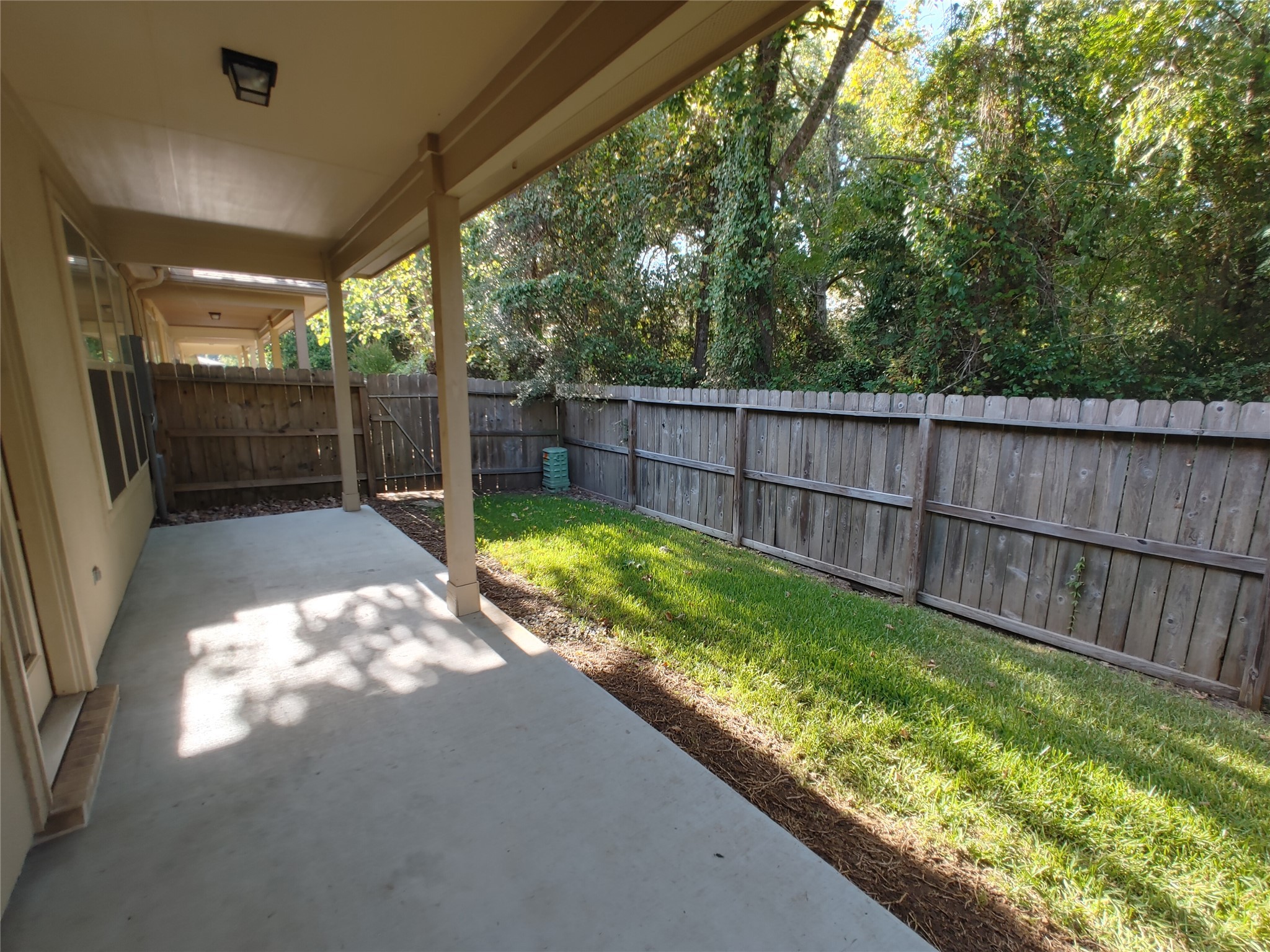9014 Meacom Drive Conroe, TX 77384 - Photo 37 of 37 a view of backyard with a large tree and wooden fence