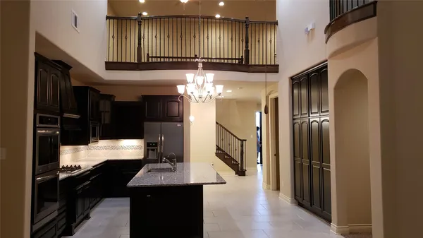 a kitchen with refrigerator and window