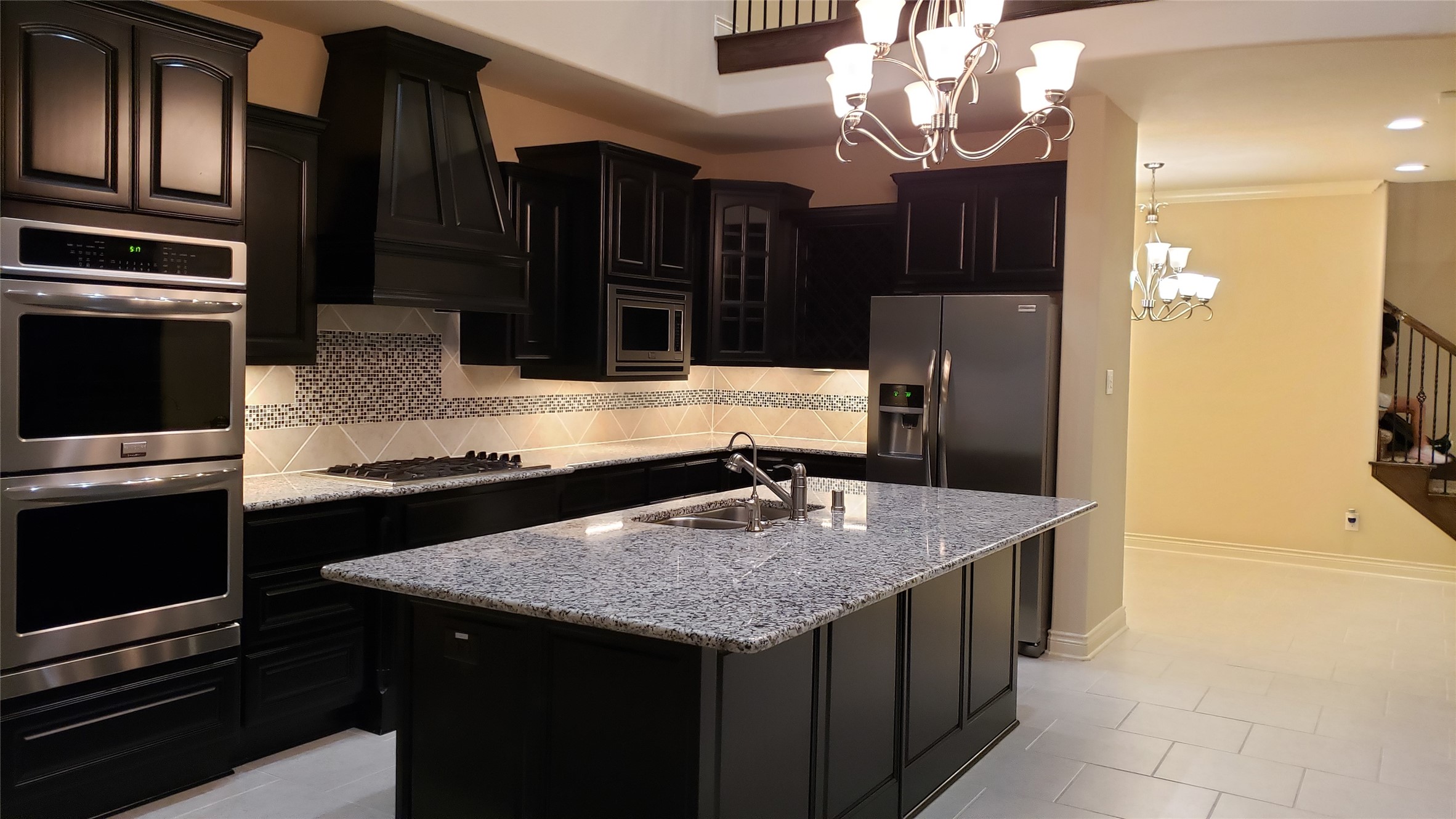 9014 Meacom Drive Conroe, TX 77384 - Photo 6 of 37 a kitchen with stainless steel appliances granite countertop a sink stove and refrigerator