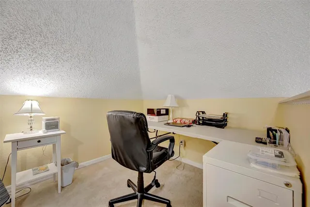 a living room with furniture a flat screen tv and a large window