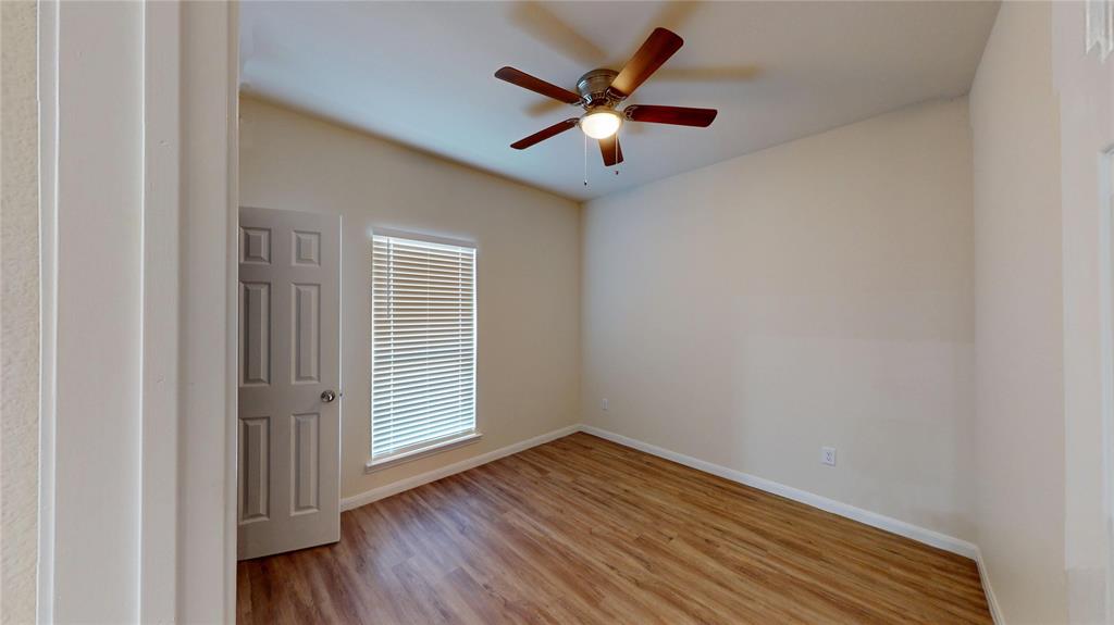 18636 Doubletree Drive Justin, TX 76247 - Photo 14 of 35 an empty room with wooden floor and windows
