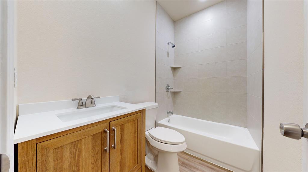 18636 Doubletree Drive Justin, TX 76247 - Photo 18 of 35 a bathroom with a sink toilet vanity and shower