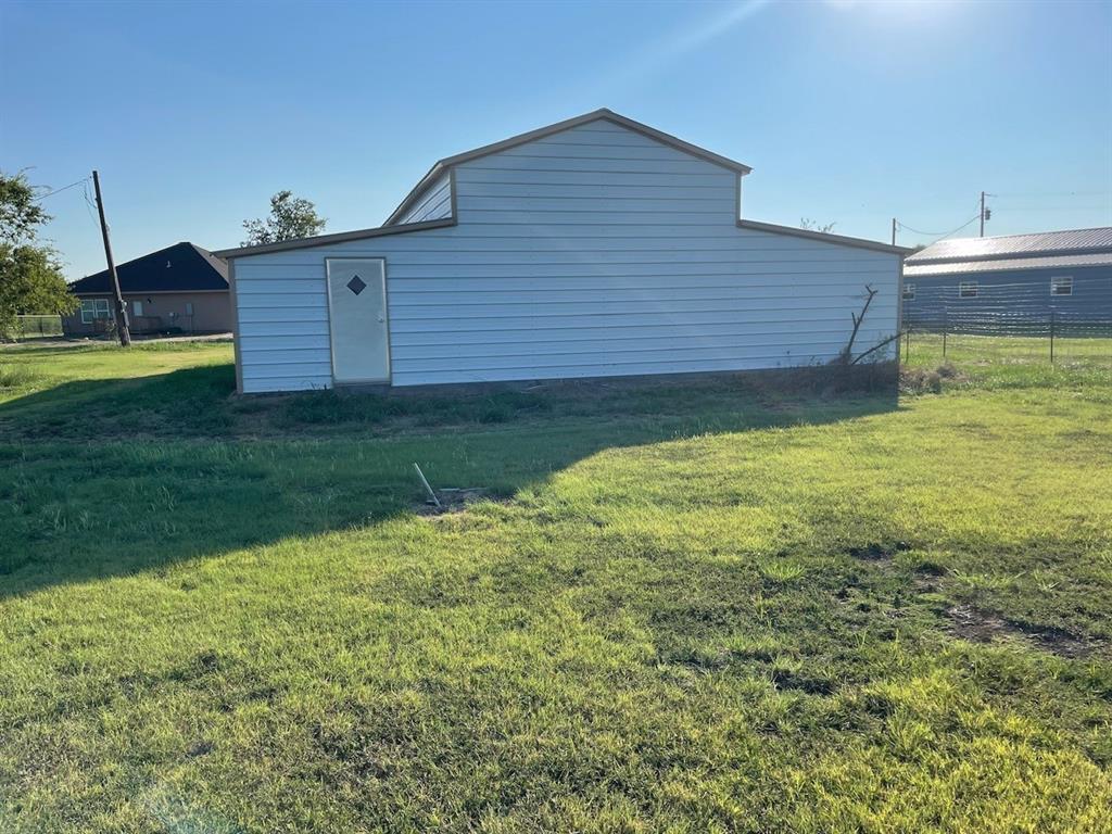 18636 Doubletree Drive Justin, TX 76247 - Photo 26 of 35 a view of a backyard with table and chairs and wooden fence