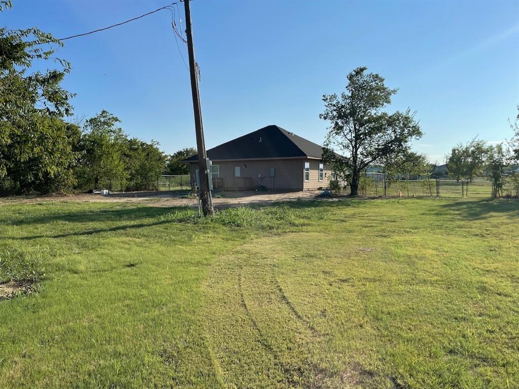 18636 Doubletree Drive Justin, TX 76247 - Photo 34 of 35 a big yard with road and trees in the background