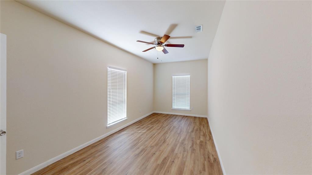 18636 Doubletree Drive Justin, TX 76247 - Photo 8 of 35 an empty room with wooden floor and windows