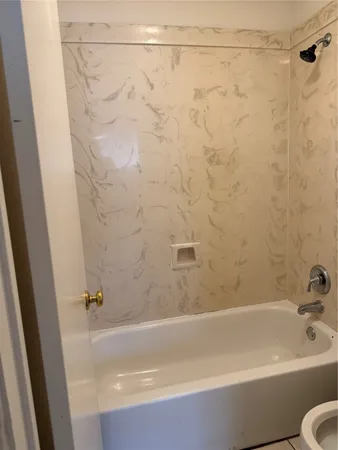 a bathroom with a shower and a bath tub