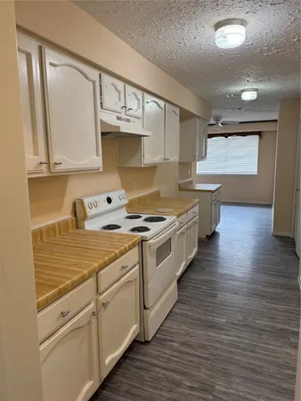 a kitchen with stainless steel appliances a stove top oven a sink and cabinets