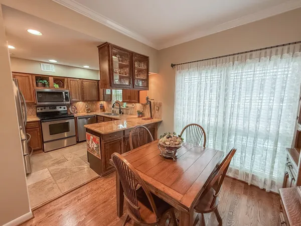 a kitchen with sink a microwave and cabinets