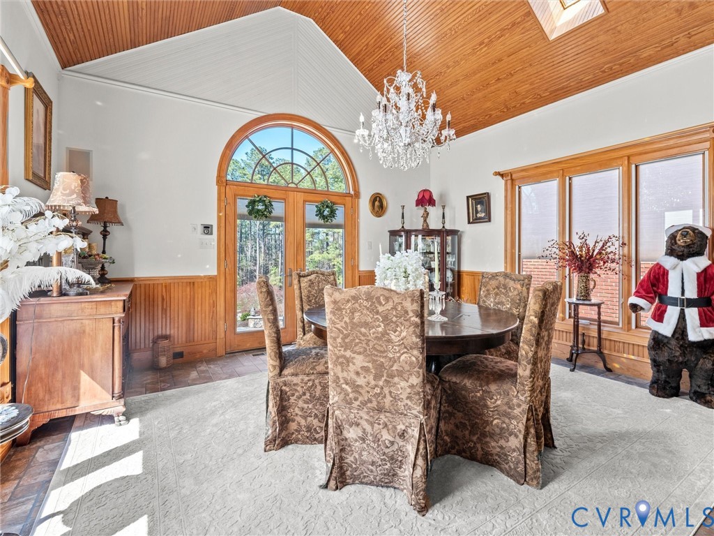 24200 Pear Orchard Road Moseley, VA 23120 - Photo 38 of 66 a view of a dining room with furniture a chandelier and a large window