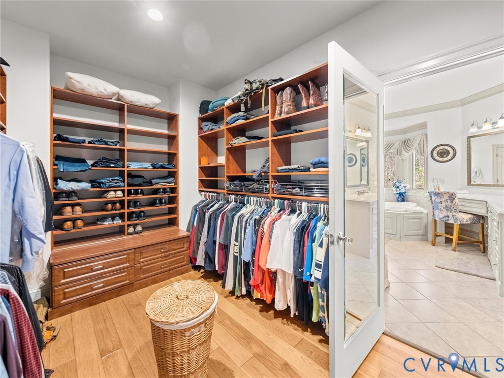 24200 Pear Orchard Road Moseley, VA 23120 - Photo 47 of 66 Custom walk-in closet in primary bedroom