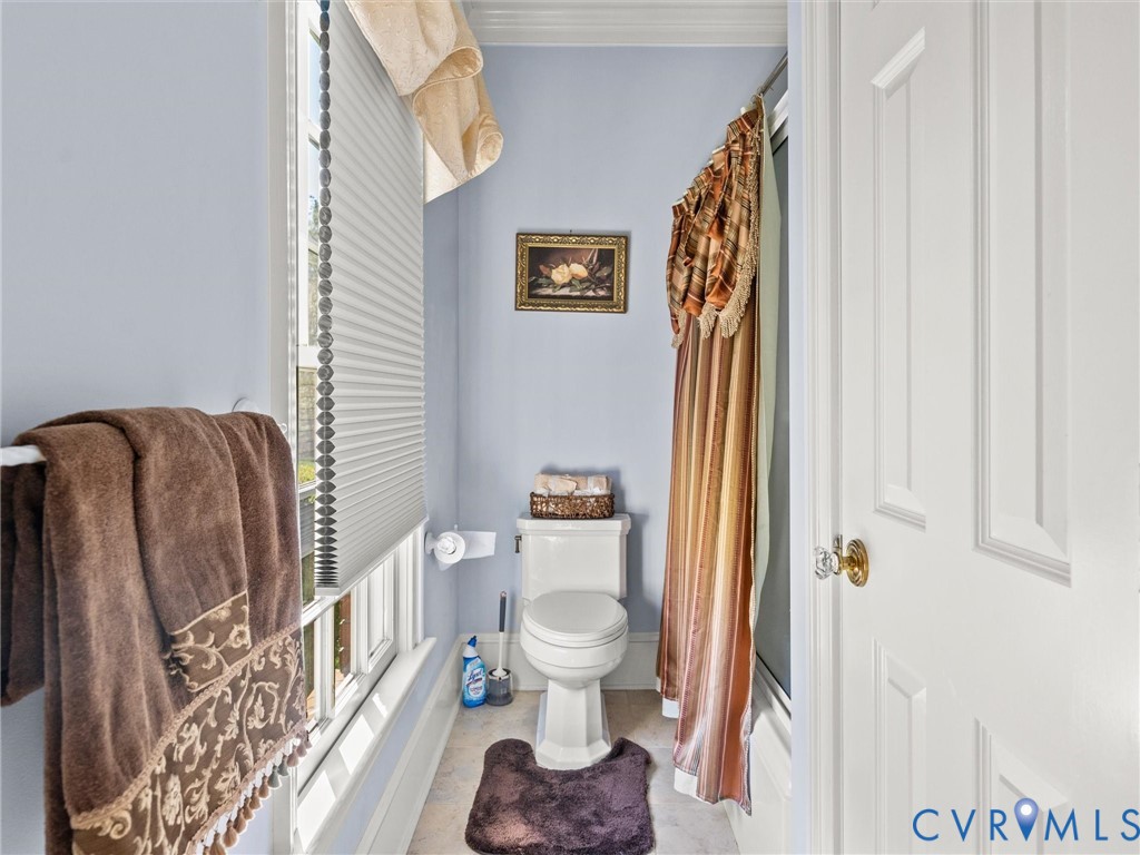 24200 Pear Orchard Road Moseley, VA 23120 - Photo 53 of 66 a bathroom with a toilet and a shower curtain