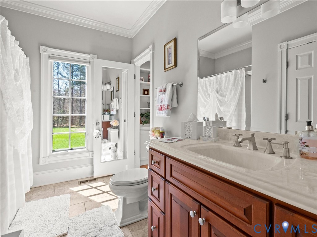 24200 Pear Orchard Road Moseley, VA 23120 - Photo 58 of 66 a bathroom with a granite countertop sink and a mirror