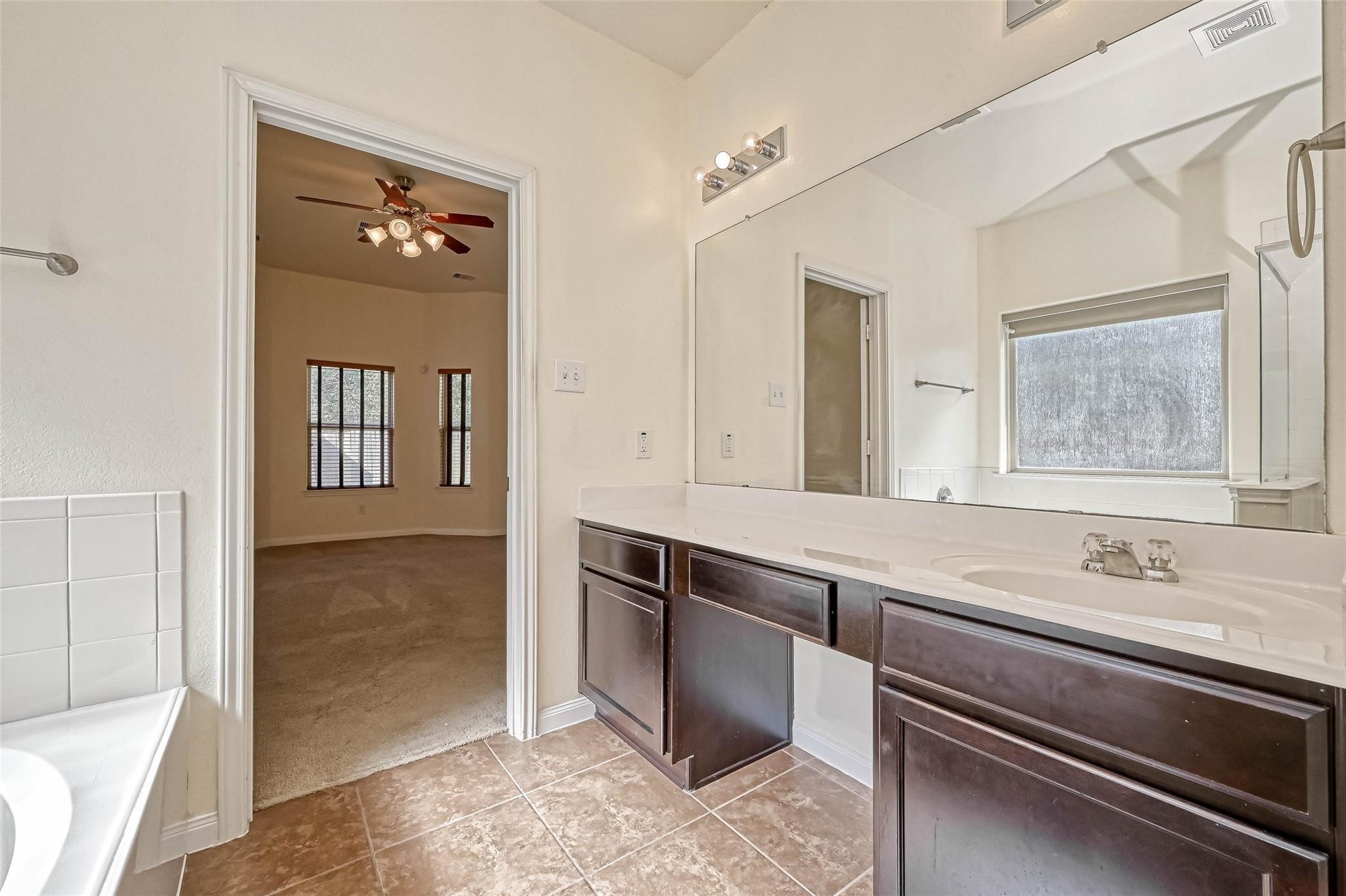 20555 Bonds Creek Lane Spring, TX 77388 - Photo 25 of 36 a spacious bathroom with a sink and a mirror