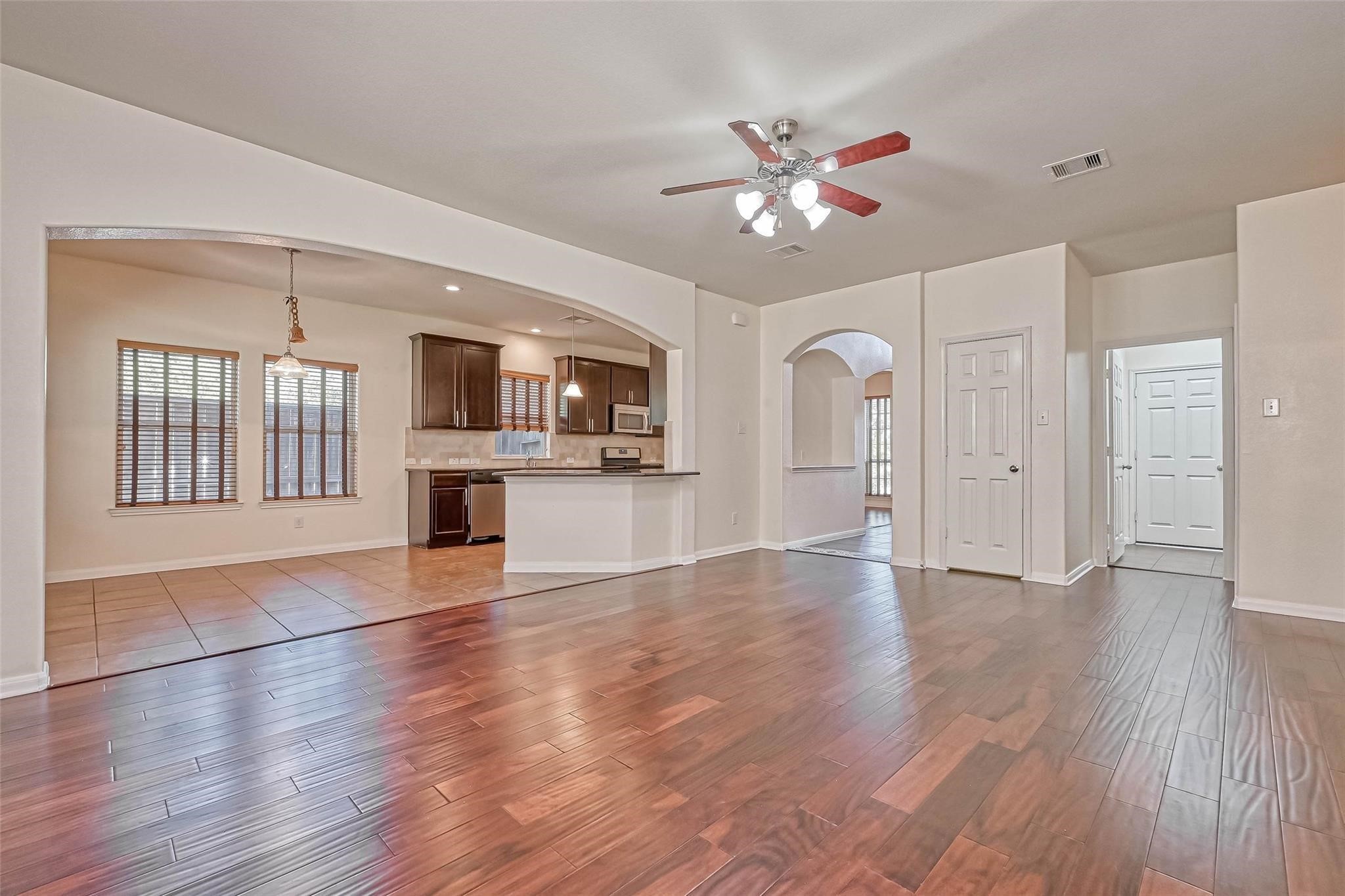 20555 Bonds Creek Lane Spring, TX 77388 - Photo 3 of 36 a view of an empty room with window and wooden floor