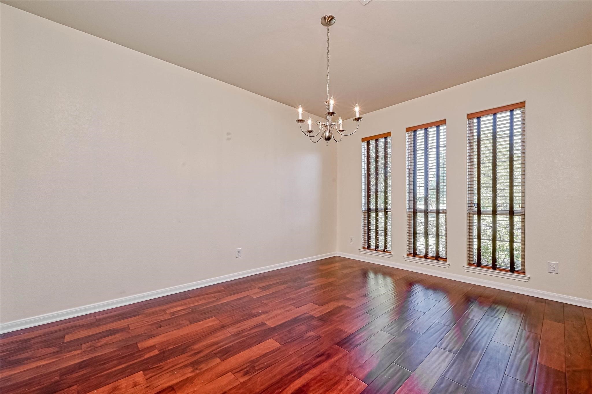 20555 Bonds Creek Lane Spring, TX 77388 - Photo 31 of 36 wooden floor in an empty room with a window