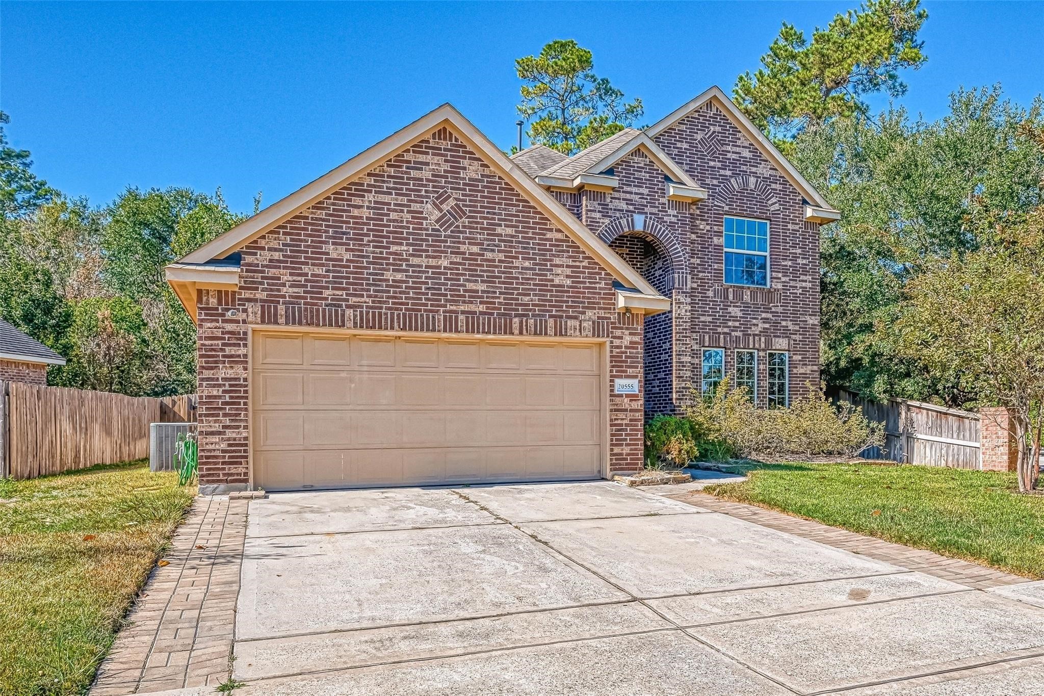 20555 Bonds Creek Lane Spring, TX 77388 - Photo 35 of 36 a front view of a house with a yard and a garage