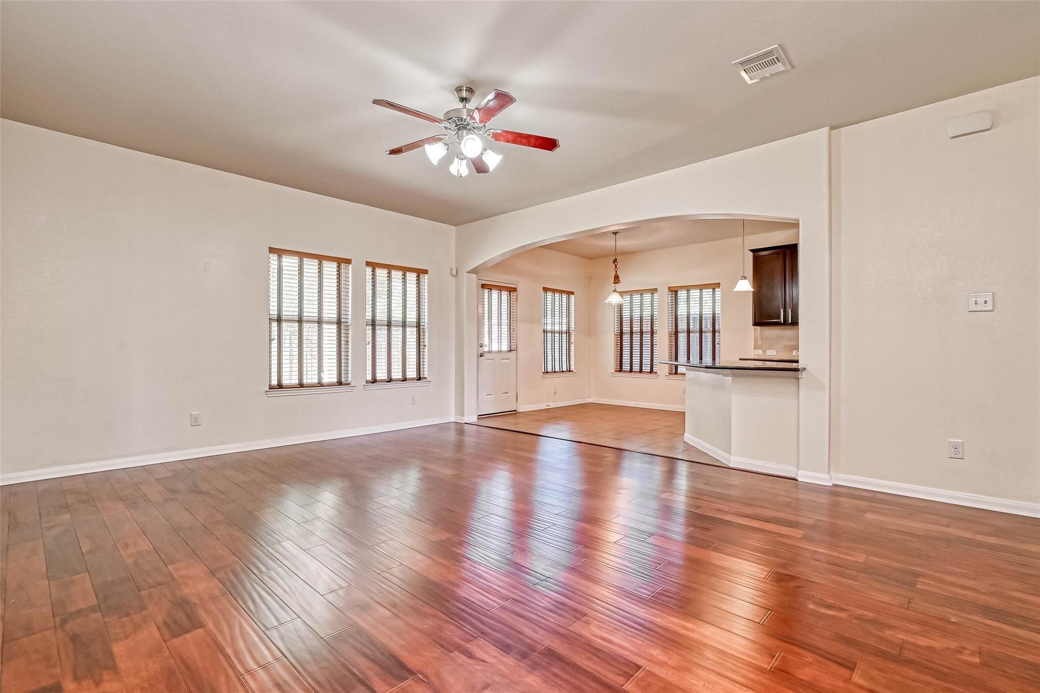 20555 Bonds Creek Lane Spring, TX 77388 - Photo 4 of 36 a view of an empty room with wooden floor and fan