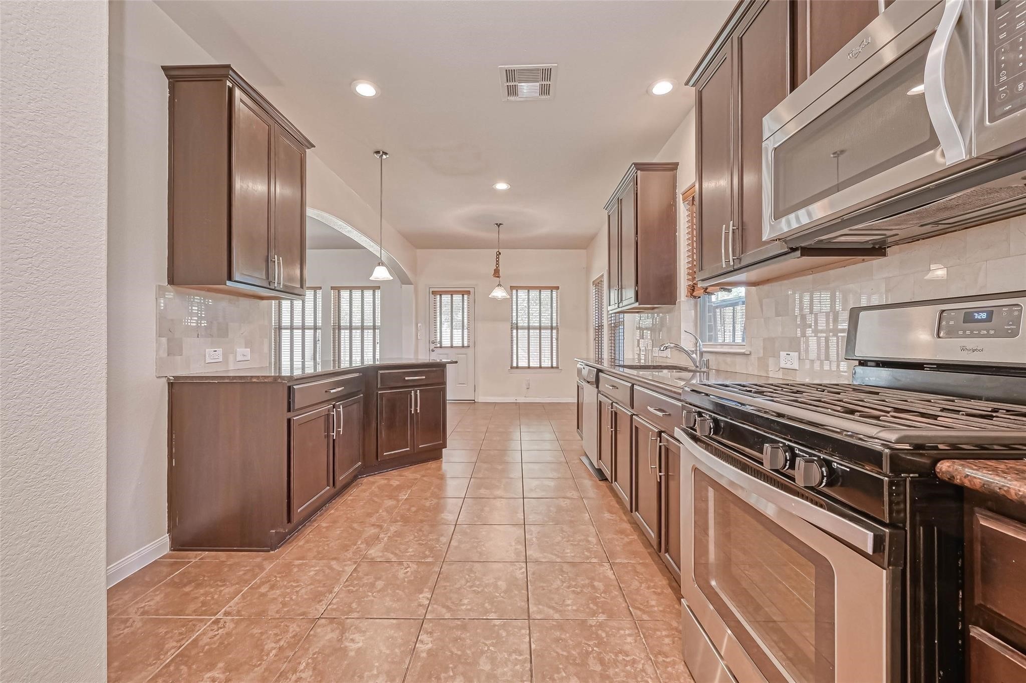 20555 Bonds Creek Lane Spring, TX 77388 - Photo 6 of 36 a large kitchen with stainless steel appliances granite countertop a stove a sink and a refrigerator