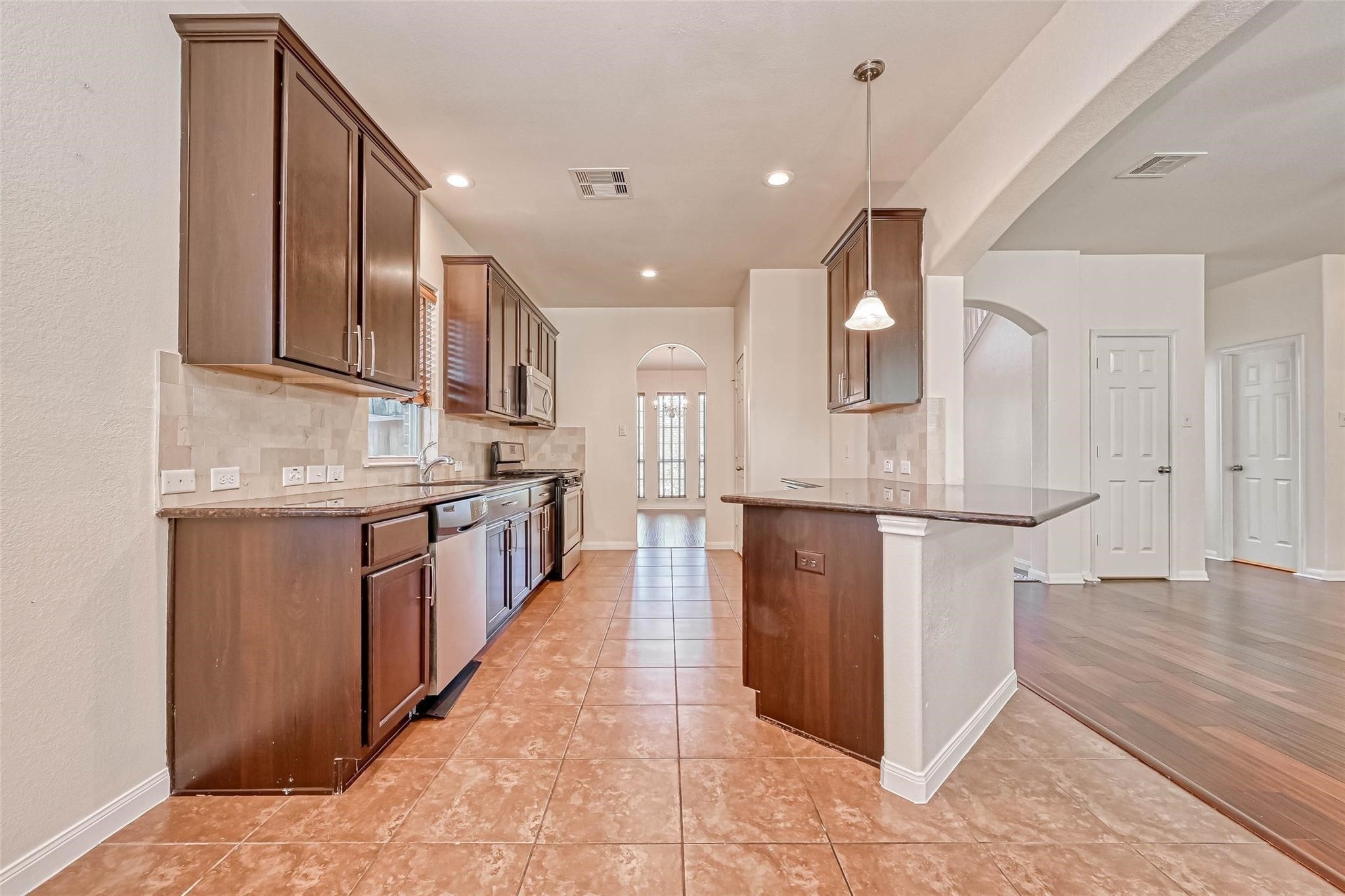 20555 Bonds Creek Lane Spring, TX 77388 - Photo 10 of 36 a kitchen with stainless steel appliances granite countertop a refrigerator and a sink