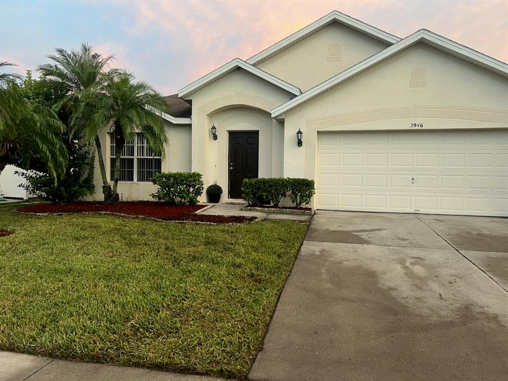 2946 Conner Lane Kissimmee, FL 34741 - Photo 1 of 13 a front view of a house with garden