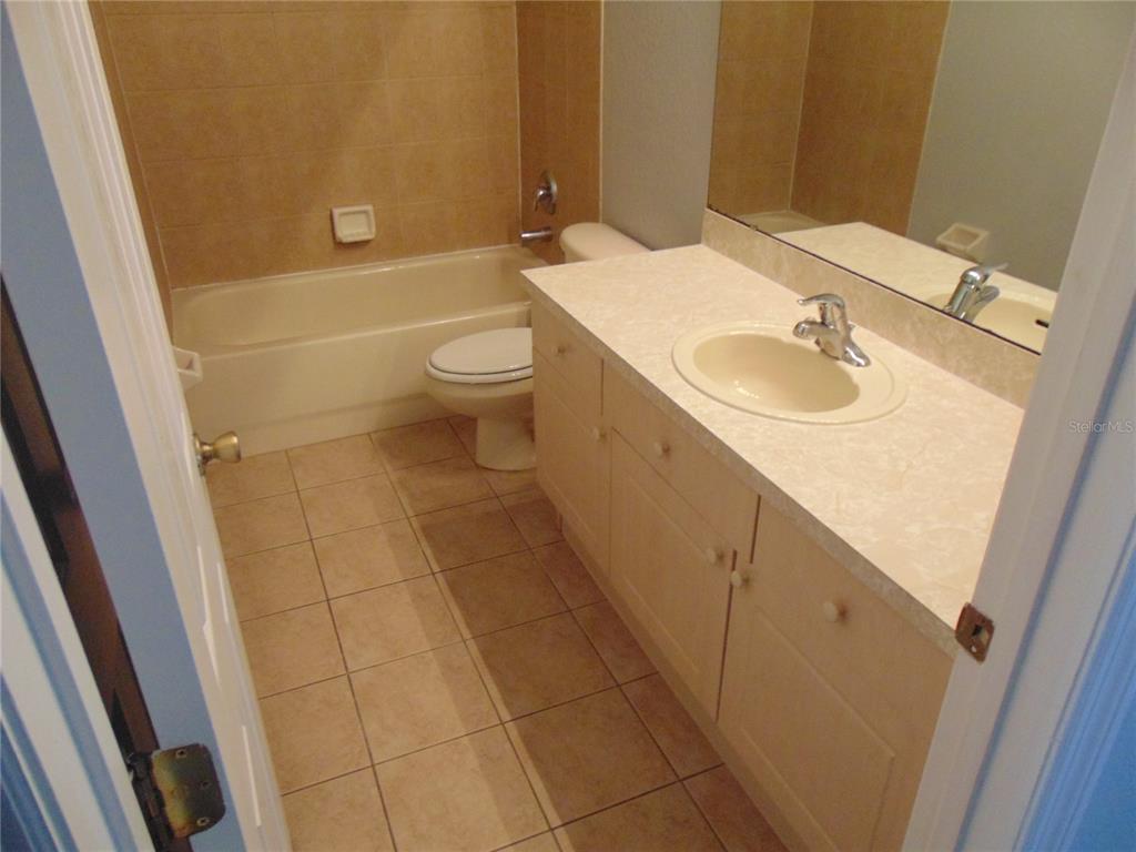2946 Conner Lane Kissimmee, FL 34741 - Photo 6 of 13 a bathroom with a sink a toilet and shower