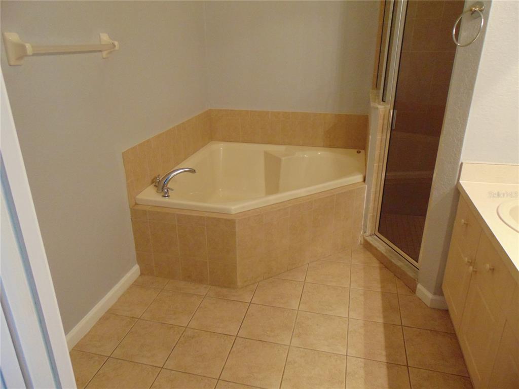 2946 Conner Lane Kissimmee, FL 34741 - Photo 7 of 13 a white bath tub sitting in a bathroom