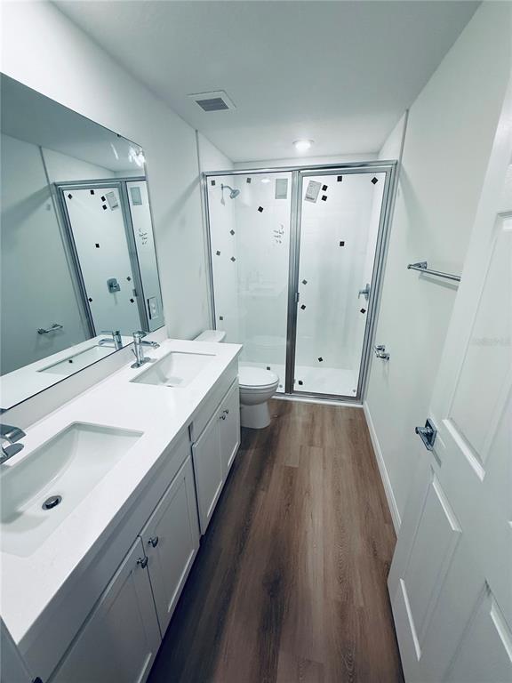 12 Slipper Flower Path East Palm Coast, FL 32164 - Photo 14 of 36 a spacious bathroom with a double vanity sink a toilet and a mirror