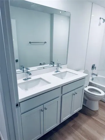 a bathroom with a double vanity sink and a mirror
