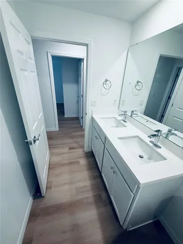 a bathroom with a double vanity sink and a mirror