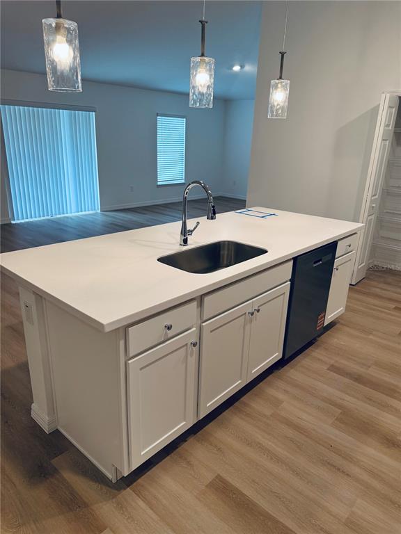 12 Slipper Flower Path East Palm Coast, FL 32164 - Photo 4 of 36 a kitchen with a sink cabinets and wooden floor