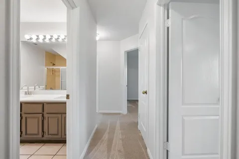 an empty room with ceiling fan and window